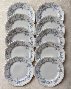 six blue and white plates stacked on top of each other