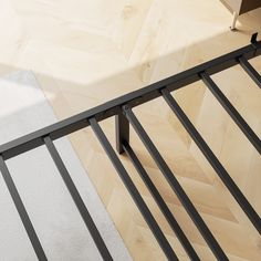 a close up of a metal railing on a wooden floor with white carpet and wood floors