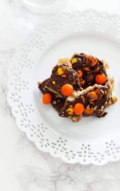 a white plate topped with pieces of chocolate and candy