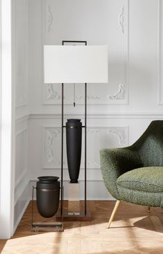 a chair and lamp in a room with white walls