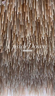 the words inside down are made out of wooden sticks and hanging from the ceiling in front of