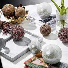 the table is decorated with silver and red ornaments on it's marble slabd surface