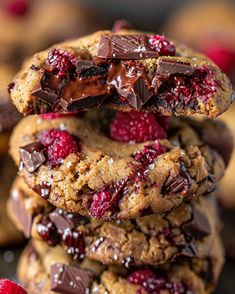 chocolate chip cookies stacked on top of each other with raspberries