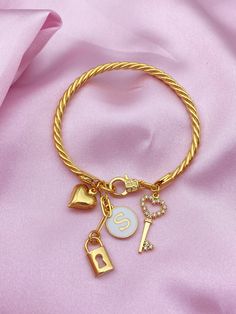 Custom Heart Lock and Key Charm Bangle Bracelet,Personalized Charm Bracelet,Bangle Bracelet for Women,Personalized Gifts,Gift for Her PRODUCT DETAILS ; The product is 18K Brass Gold Plated. Adjustable. Designed with 4 Charms in total. It is sent with personalized letter. You need to write your initial in the personalization section. This bracelet is an elegant and special design representing love that you can get on special occasions. It's time to pamper your loved ones or yourself by customizin Gift Bangle Heart Bracelet With Jubilee Detail, Heart Charm Bangle Bracelets For Friendship, Friendship Heart Charm Bangle Bracelet, Friendship Bangle Bracelet With Heart Charm, Metal Bangle Crystal Bracelet As Gift, Gold Charm Bangle Bracelet, Gold Heart Bangle Bracelet For Friendship, Gold Bangle Heart Bracelet For Friendship, Friendship Charms Bangle Jewelry