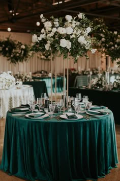 the centerpiece is surrounded by white flowers and greenery