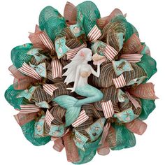 a wreath with a mermaid sitting on top of it's sides and ribbons around the edges