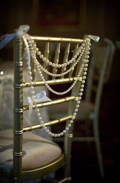 a gold chair with pearls on the back and seat is seen in this instagram photo