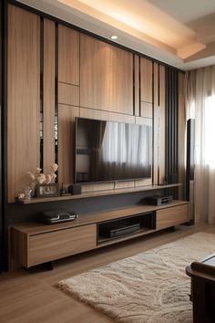 a modern living room with wood paneling and large television on the entertainment center wall