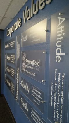 a wall that has some type of business signs on it and is blue with white lettering