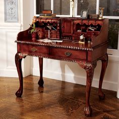 an old fashioned desk with two mirrors on it's top and one drawer open