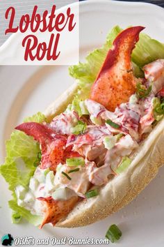 lobster roll with lettuce and tomato on it sitting on a white paper plate