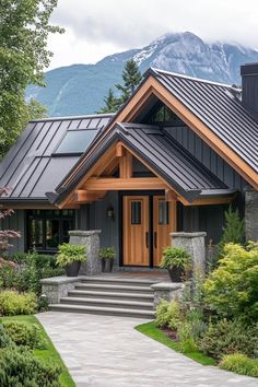 a house with a metal roof and stone steps leading up to the front door