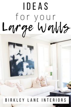 a living room with white furniture and text overlay that reads 10 ideas for your large walls