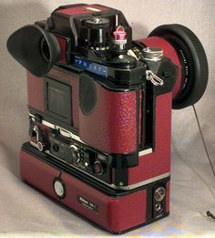 a red camera sitting on top of a table