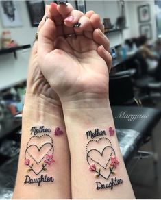 two people with matching tattoos on their arms