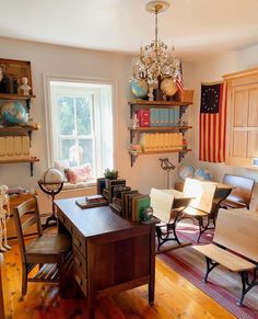 a living room filled with furniture next to a window covered in american flag pillows and books