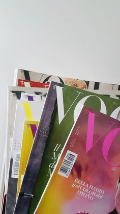 several magazines stacked on top of each other