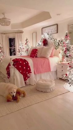 a dog laying on the floor next to a bed in a room decorated for christmas