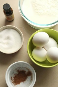 eggs and other ingredients in bowls on a counter top, including milk, sugar, and flour