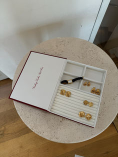 an open jewelry box sitting on top of a table