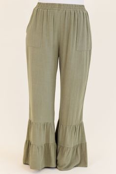 Introducing our Mystery of Love Pants in dusty olive! Made with a comfortable linen blend, these wide leg pants feature pockets and an elastic waistband for the perfect fit! The tiered ruffled leg design adds a touch of flair to your wardrobe! Pair with your favorite blouse or bodysuit for a stylish and effortless look! 70% Rayon, 30% Linen Olive Wide Leg Pants For Spring, Bohemian Ruffled Bottoms In Solid Color, Casual Linen Tiered Skirt Bottoms, Casual Linen Tiered Skirt, Chic Linen Bottoms With Ruffles, Spring Linen Bottoms With Ruffle Hem, Chic Green Bottoms With Ruffle Hem, Chic Ruffled Linen Bottoms, Casual Wide Leg Bottoms With Ruffle Hem