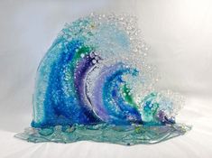 an artistic glass sculpture made to look like a wave