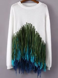 a white sweater with blue and green feathers on it