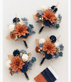 three bridal bouquets with blue, orange and white flowers on top of each other