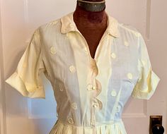 "This is a vintage dress from the late 1950s or likely early 60s. It is a small or petite size, with a 26 inch waist.  It is a light, pale yellow cotton, with a woven polka dot pattern. It is short sleeved. The bodice is scalloped at the edge where it buttons. It also has shook and eye at the waist. There are string belt loops, but alas, the belt is lost to time. The skirt is gathered into pleats at the waist. A pretty summer dress!  Condition is ok, not perfect. There are 2 small holes where ol Pretty Summer Dresses, 60s Dress, Polka Dot Pattern, Vintage Cotton, Petite Size, Cotton Dresses, Dress Clothes For Women, Vintage Dresses, Dress Outfits