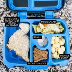 a blue lunch box with compartments filled with different food items and labeled in the words