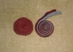 two crocheted pieces of yarn sitting next to each other on a carpeted floor