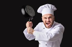 a man in chef's outfit holding a frying pan with an angry look on his face