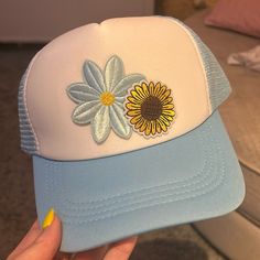 Light Blue Patched Unisex Trucker Hat With Sunflower And Daisy Blue Summer Trucker Hat, Summer Blue Snapback Trucker Hat, Blue Snapback Trucker Hat For Summer, Blue Curved Brim Trucker Hat For Summer, Summer Blue Adjustable Trucker Hat, Trendy Blue Trucker Hat For Vacation, Blue Adjustable Summer Trucker Hat, Blue Adjustable Trucker Hat For Summer, Adjustable Blue Trucker Hat For Summer