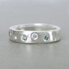 a white gold ring with five diamonds