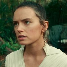 a woman in a star wars outfit looking at the camera with an angry look on her face