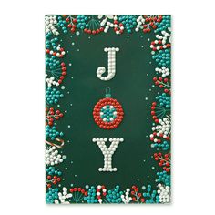 a christmas card with the word joy on it and beaded ornaments in red, white, and blue