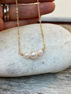 "7-7.5mm and 5-5.5mm White rose tone Akoya Culture Pearl (from Japan) in 14K Gold filled or Serling silver chain Beautiful Elegant and Classic look. Perfect gift for any occasion Holidays, Birthday or just something nice as a gift ◈ Handmade in the U.S.A. ◈ Akoya Culture Pearl: 1 / 7-7.5mm and 2 / 5-5.5mm white rose tone pearls ◈ Metal: 14K gold filled or sterling silver ◈ Chain Length:15\" 16\" 17\" 18\" 19\" 20\" free shipping and a gift 🎁 My jewelry will be wrapped in a beautiful gift box re Rose Gold Pearl Necklace With Round Beads For Gift, Rose Gold Akoya Pearl Necklace Gift, Pearl Bar Necklace, Necklace Friendship, Bar Necklaces, Akoya Pearl Necklace, Rose Tone, Cultured Pearl Necklace, Black Bead Necklace