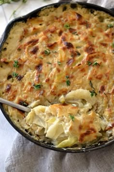 a casserole dish with chicken and dumplings in it on a white cloth