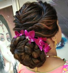 a woman with flowers in her hair is looking into the distance while wearing a pink top