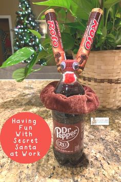 a bottle with some candy in it sitting on a counter next to a basket and potted plant