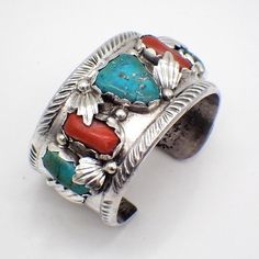 Native American Navajo sand cast sterling silver cuff bracelet, decorated with Coral and Turquoise insets and applied silver elements. This impressive bracelet is 5 1/2" long plus 1" opening, 1 3/8" wide, weighing 115.4 grams or 3.72 ozs Troy. Two stones have hair line fracture, but the stones are set very securely. EA5634 Sand Casting, Sterling Silver Cuff Bracelet, Coral Turquoise, Sterling Silver Cuff, Silver Cuff, Sterling Silber, Arm Band, Cuff Bracelet, San Jose