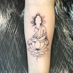 a person with a tattoo on their leg sitting in a lotus position and meditating