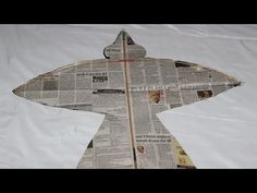 an origami bird made out of newspaper paper