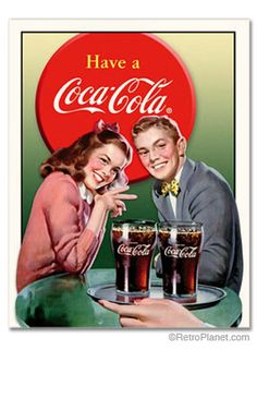 a man and woman sitting at a table with two glasses of coke