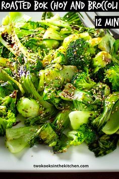 broccoli with sesame seeds and other vegetables on a white plate