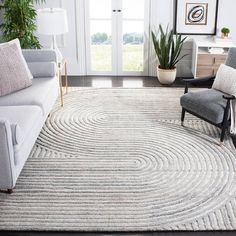 a living room filled with furniture and a rug