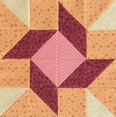 an orange and pink patchwork quilt with a star design on the center, as if it were made from fabric