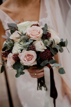 a bride holding a bouquet of flowers in her hands