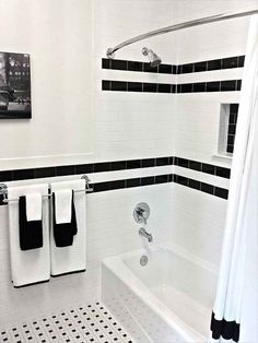 a bathroom with black and white tile on the floor, shower curtain, and bathtub