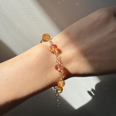 This exquisite bracelet showcases stunning Padparadscha Sapphire (simulated) faceted rondelles, meticulously hand-wired in 14K gold-filled material. Measuring 17.5 cm in length with a 2.5 cm extension, it is elegantly finished with a 14K gold-filled lobster claw clasp. Perfect for any occasion, this bracelet makes a unique and charming gift. FEATURES ◊ Padparadscha sapphire (simulated) faceted rondelles in pink orange colour ◊ 14K gold-filled wire ◊ All components of the bracelet are 14K gold-filled to ensure the highest quality. ◊ Bracelet length is approximately 17.5 cm with a 2.5 cm extender ◊ 100% nickel-free, suitable for sensitive skin JEWELRY PACKAGING ◊ All my jewellery is packaged in gift boxes, ready for gifting! PREMIUM GIFT-WRAP ◊ Add an extra special touch to your gifts by sel